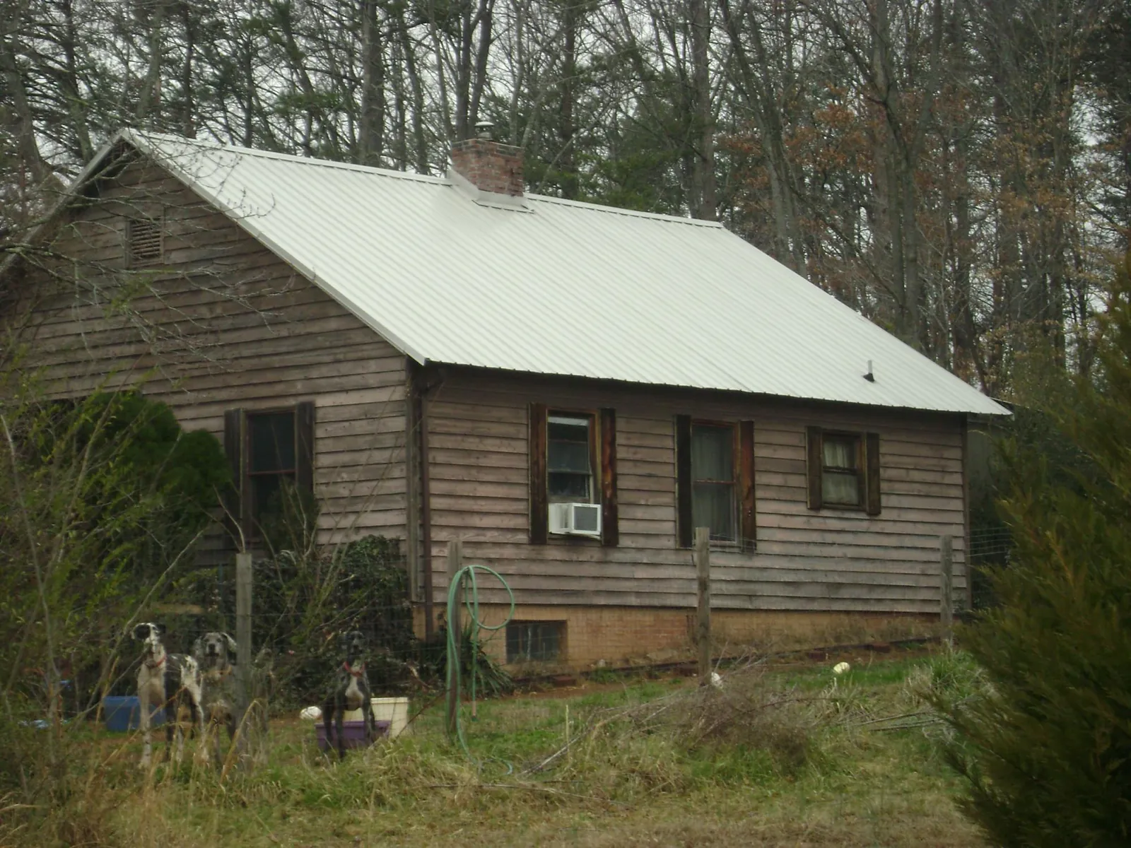 White metal roof on an old wood sided farmhouse, from a Metal Roof Installation job in Loudonville